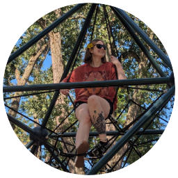 Cassia at the top of a playground rope obstacle course.