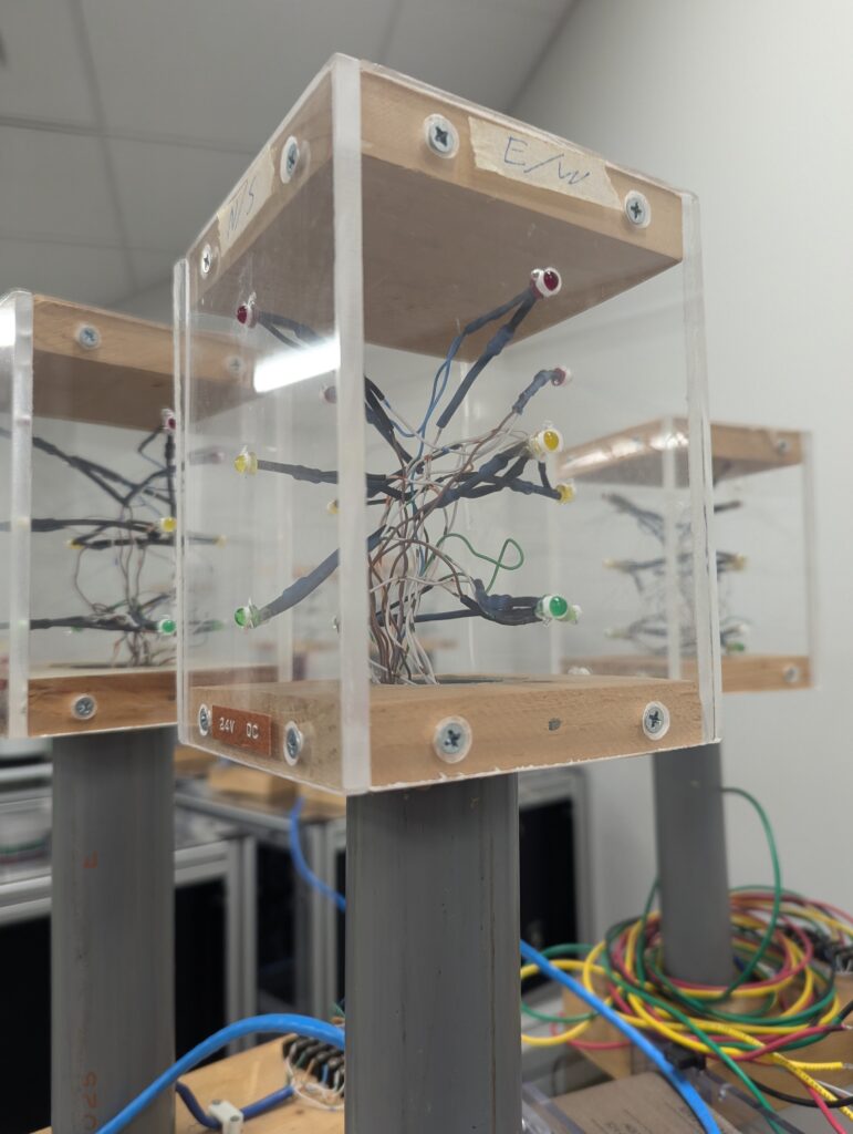 a series of green, yellow, and red LEDs embedded in plexiglass to mimic a traditional four way traffic light system